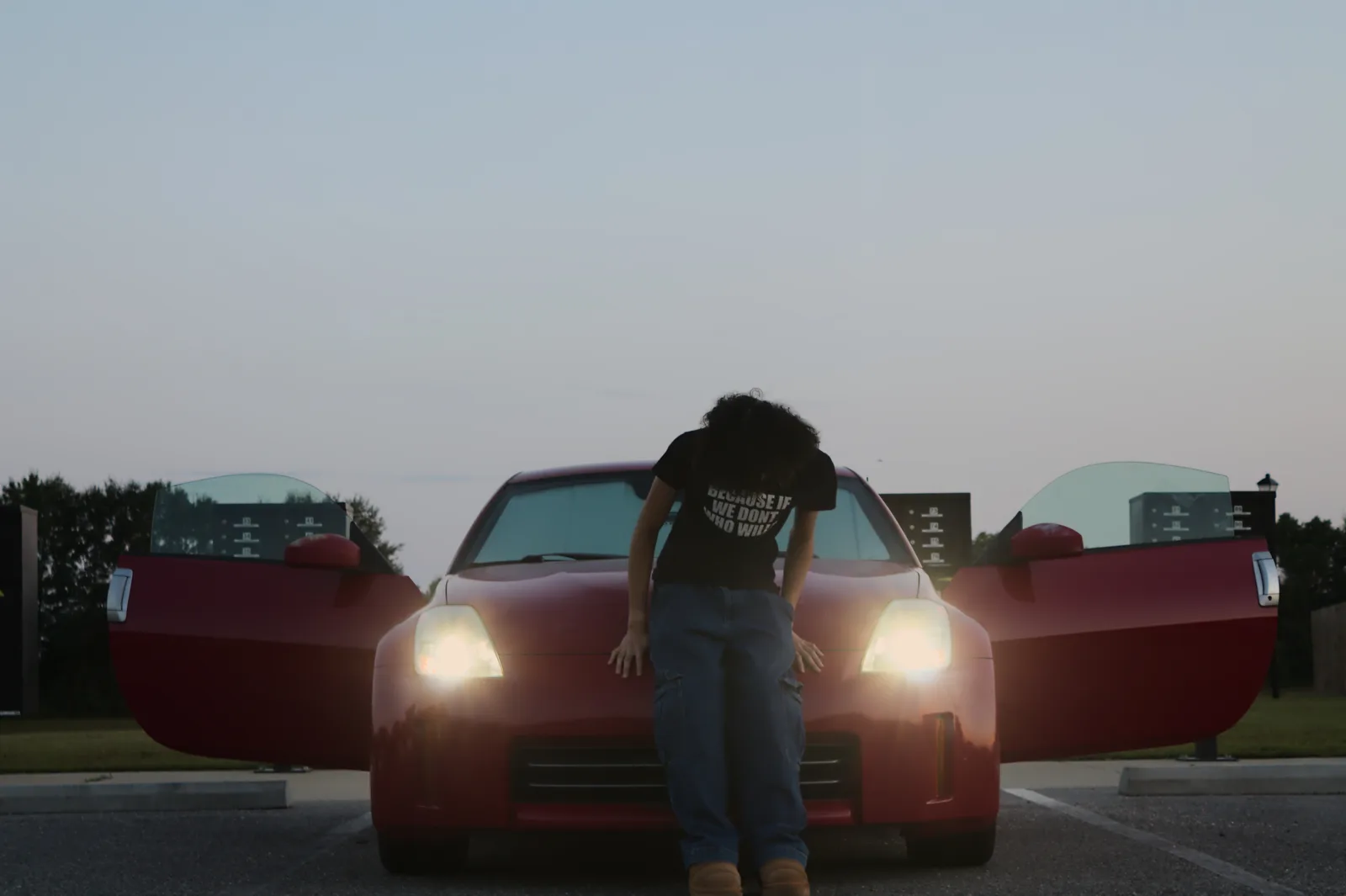 cavyion standing in front of a red car